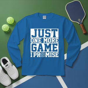 Blue long-sleeve shirt with 'Just One More Game I Promise' text on a green and blue sports-themed background.