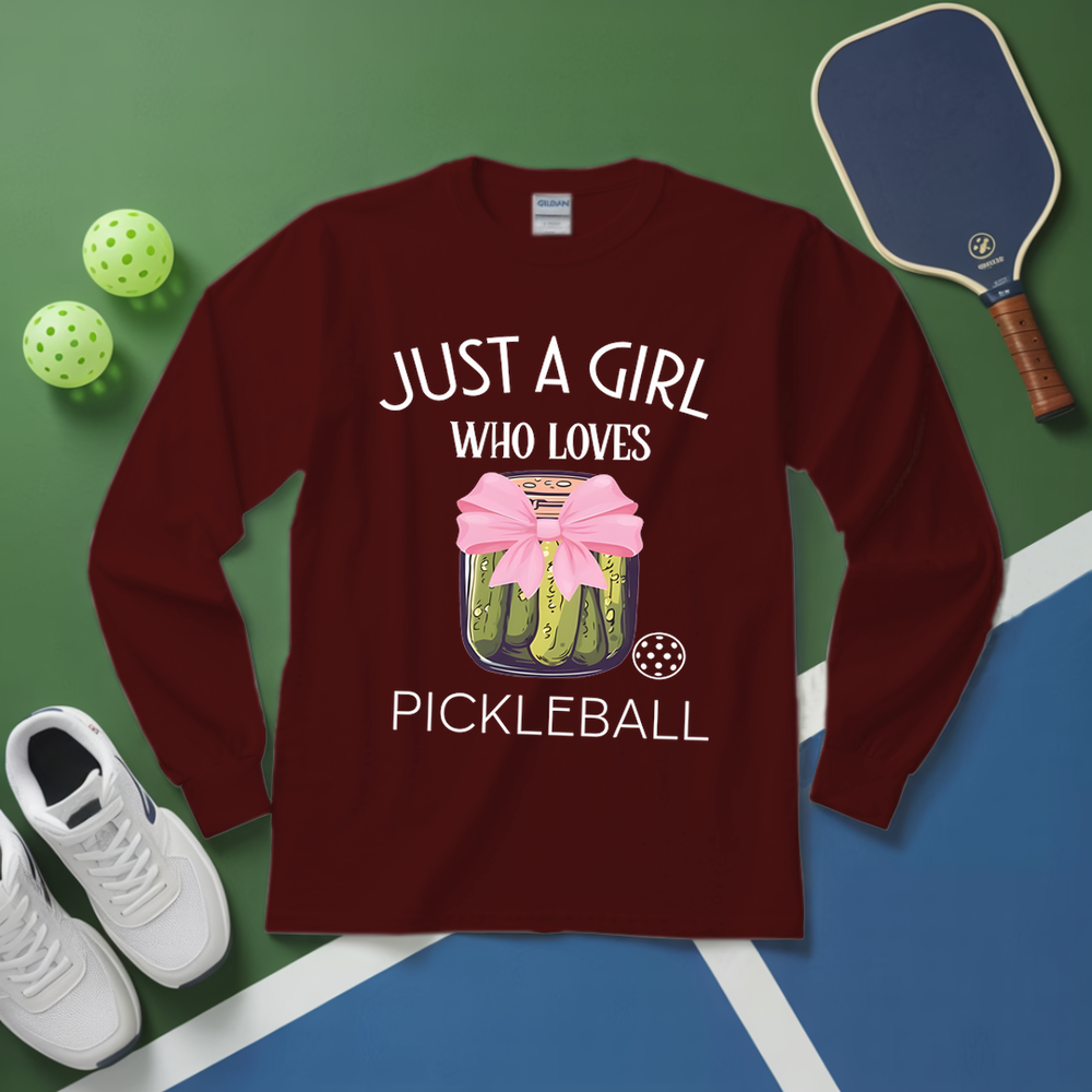 Maroon long-sleeve shirt with pickleball design and text on a green and blue background with pickleball equipment.