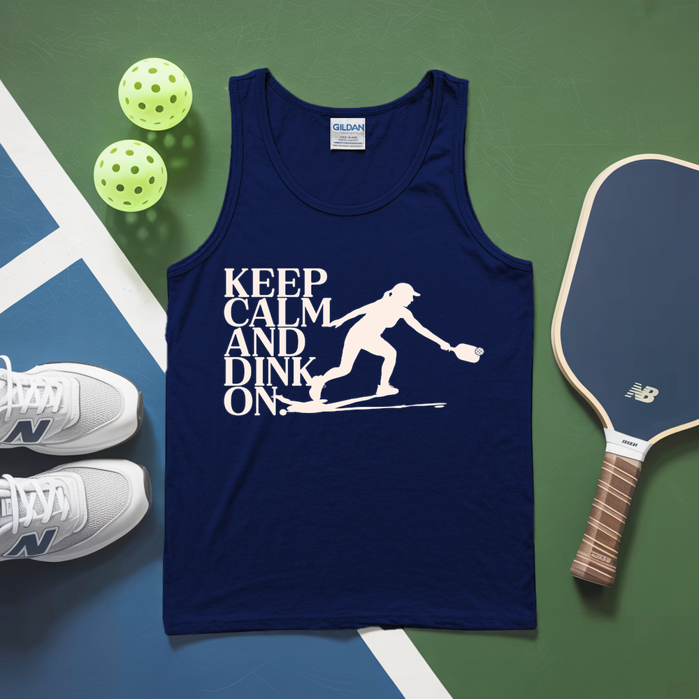 Navy tank top with 'Keep Calm and Dink On' text and pickleball equipment on a green and blue surface.