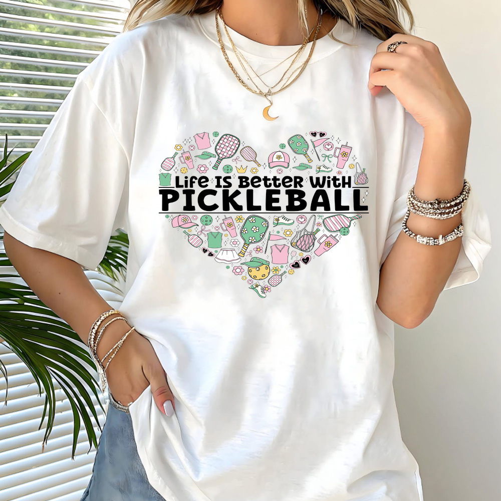 Person wearing a white t-shirt with 'Life is Better with Pickleball' design.