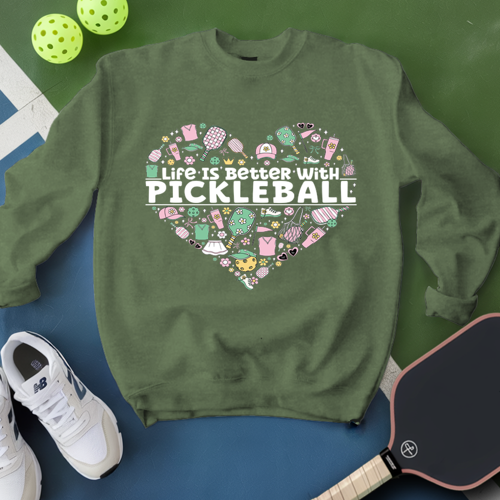 Green sweatshirt with pickleball-themed design on a blue and green background