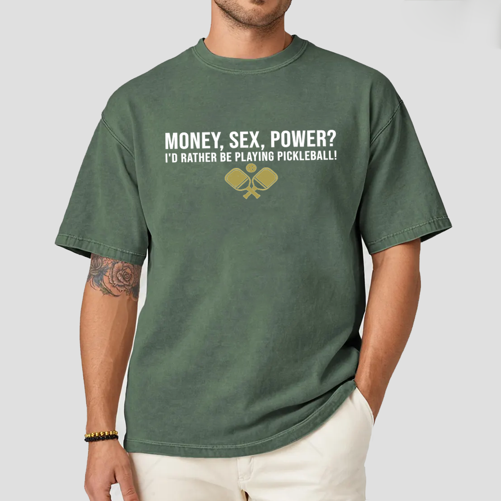 Person wearing a green t-shirt with humorous pickleball text design.
