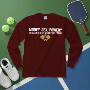 Maroon long-sleeve shirt with pickleball-themed text and graphics on a green and blue surface with pickleball equipment.