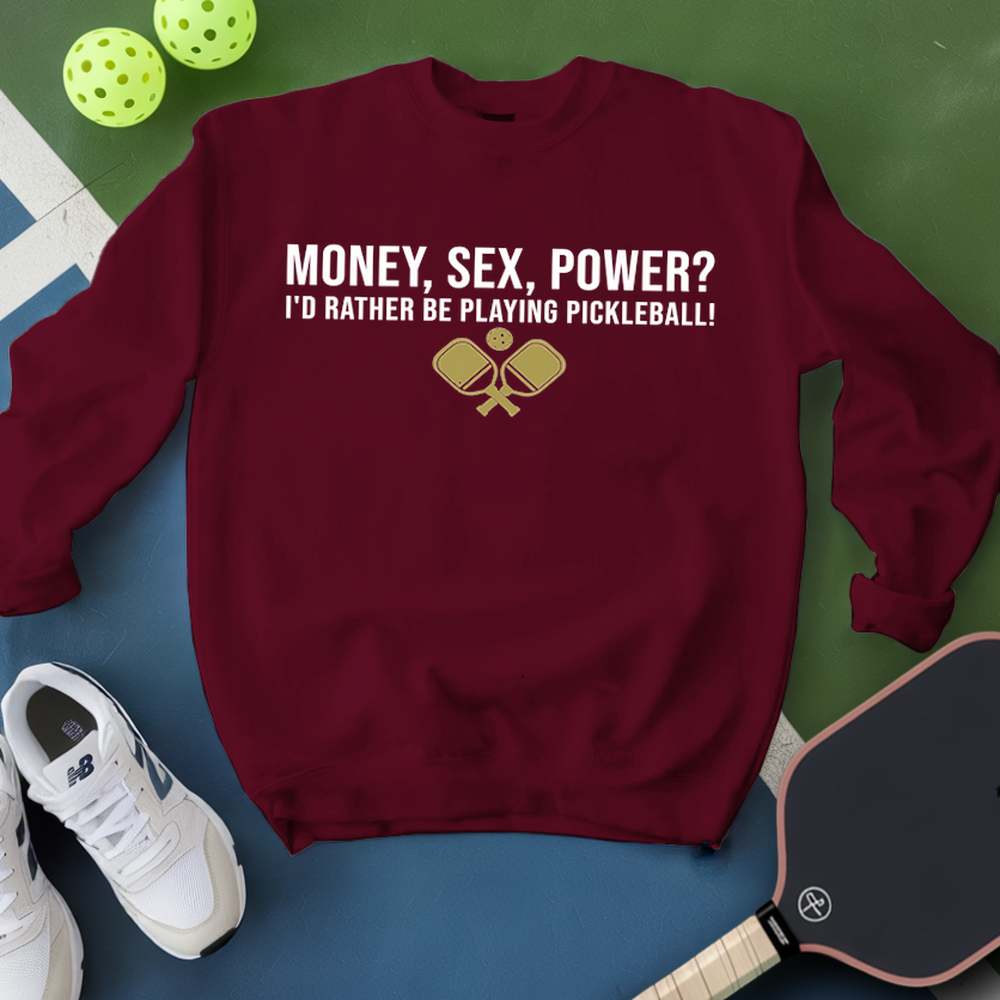Maroon sweatshirt with pickleball-themed text and graphics on a green and blue background.