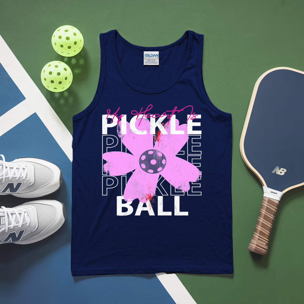 Navy tank top with pickleball design on a green and blue surface with pickleballs and a paddle.