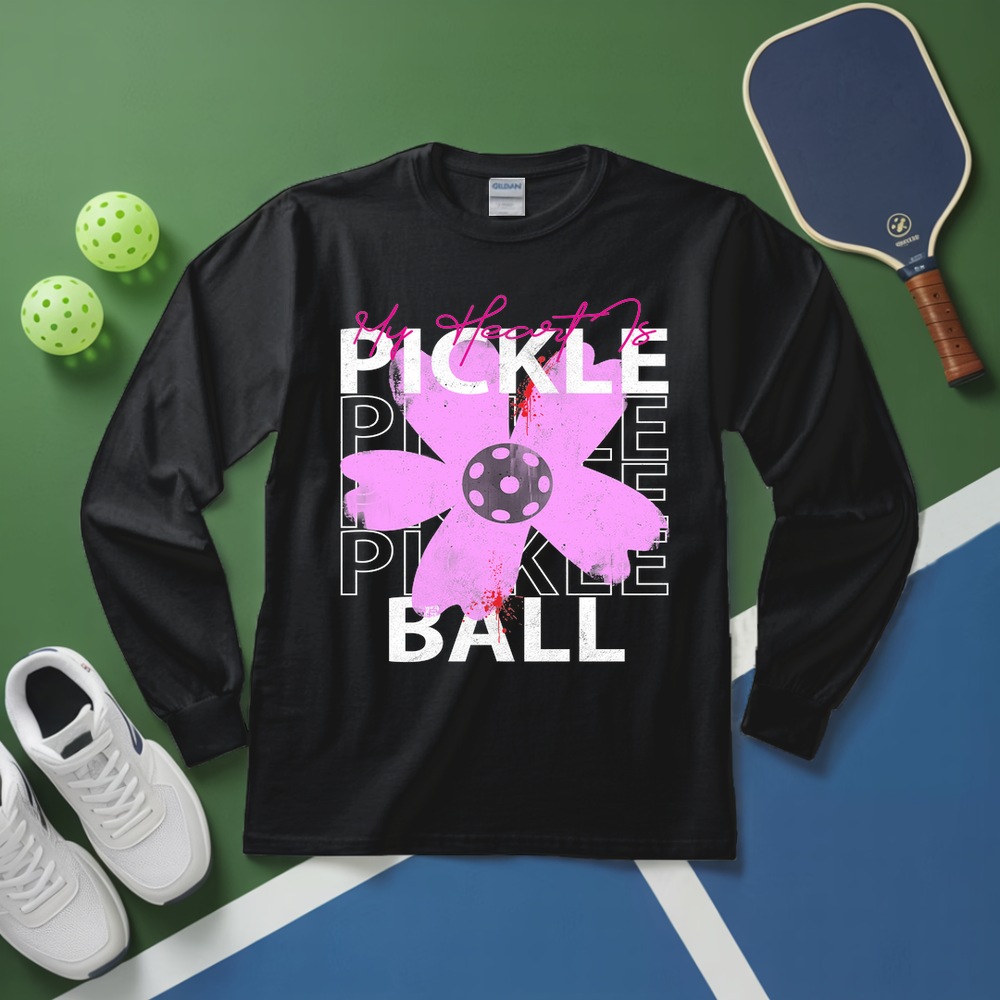 Black long-sleeve shirt with pickleball-themed design on a green and blue court background.