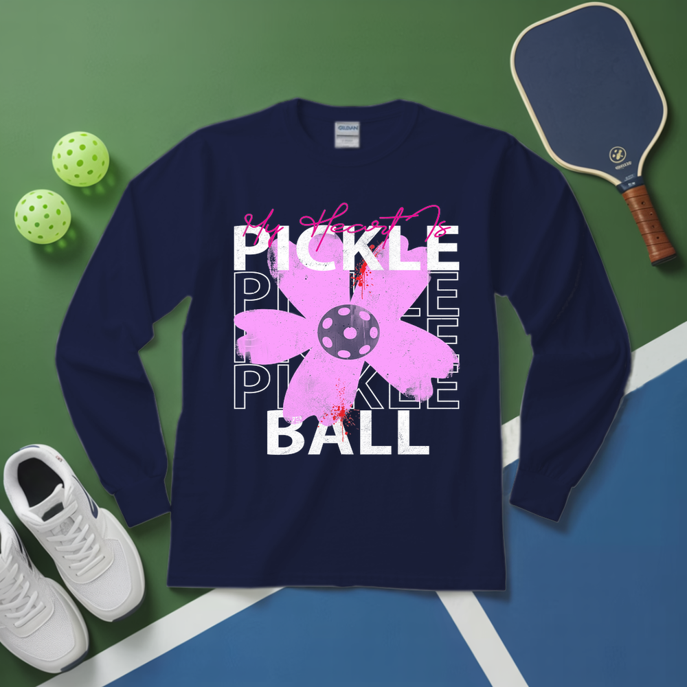 Navy blue sweatshirt with pickleball-themed design on a green and blue surface with pickleballs and a paddle.