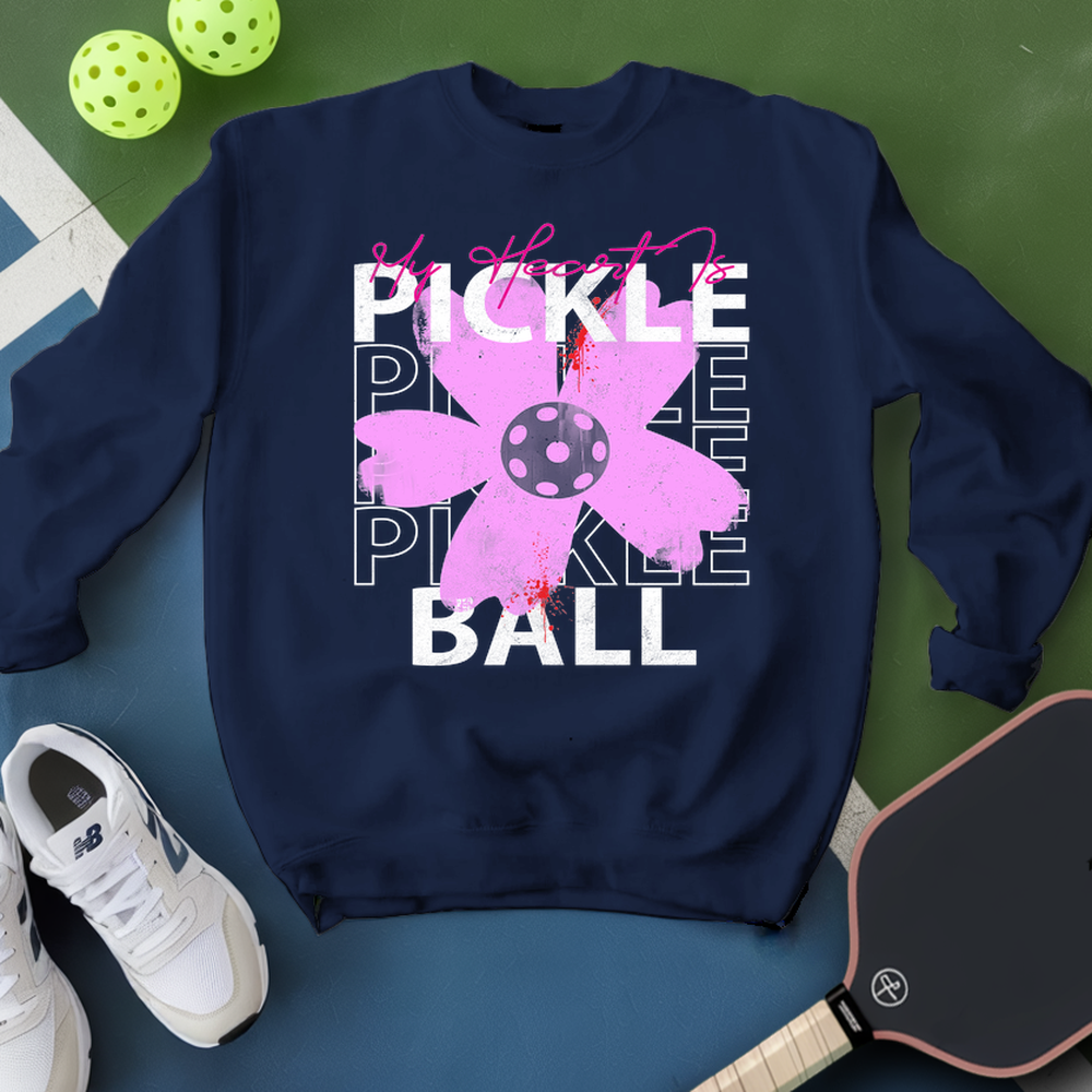 Navy blue sweatshirt with pink pickleball design on a green and blue background