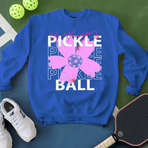 Blue sweatshirt with pickleball design on a green surface with pickleballs and a paddle.
