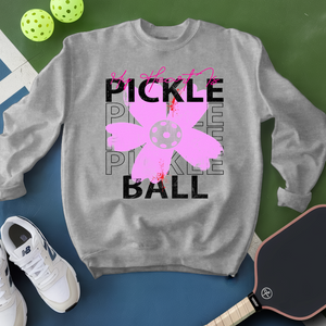 Gray sweatshirt with pickleball design on a green and blue background