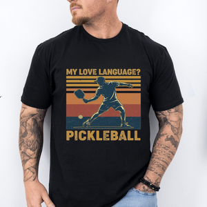 Person wearing a black t-shirt with pickleball design and text.