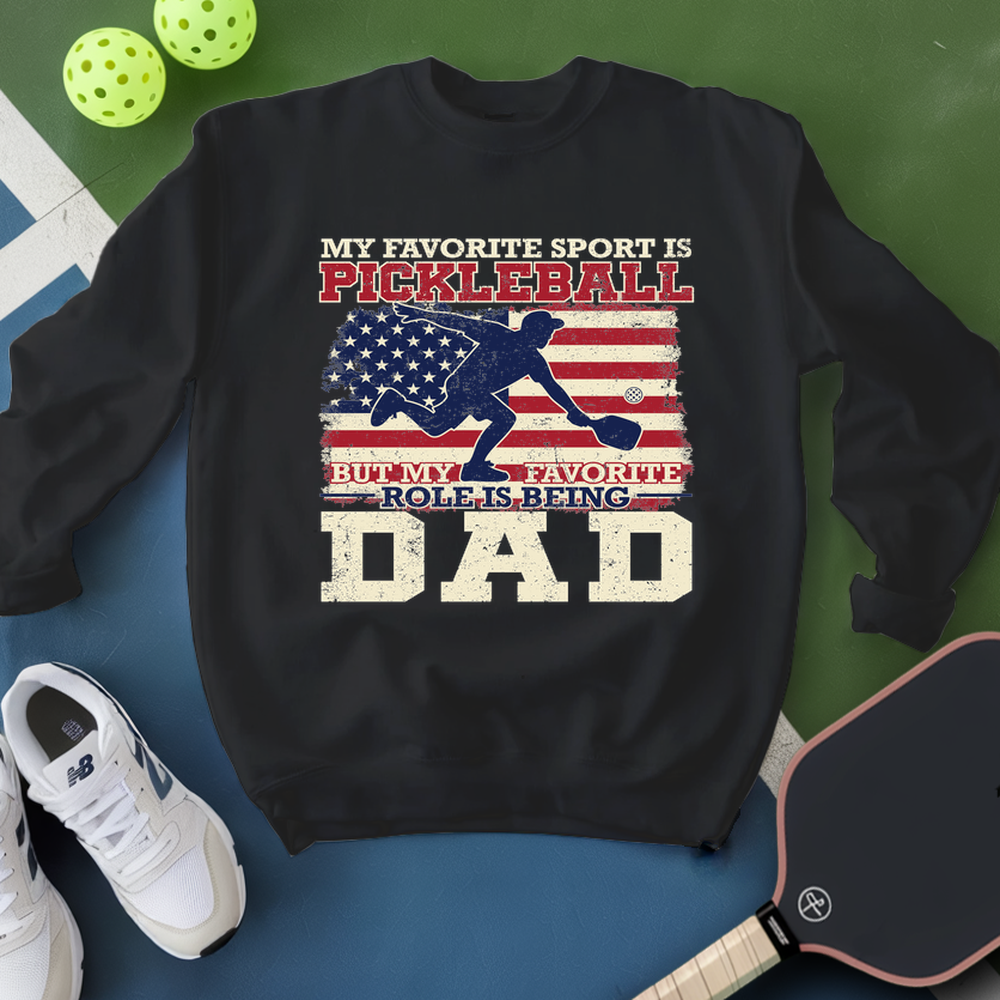 Black sweatshirt with pickleball design and text on a blue and green background