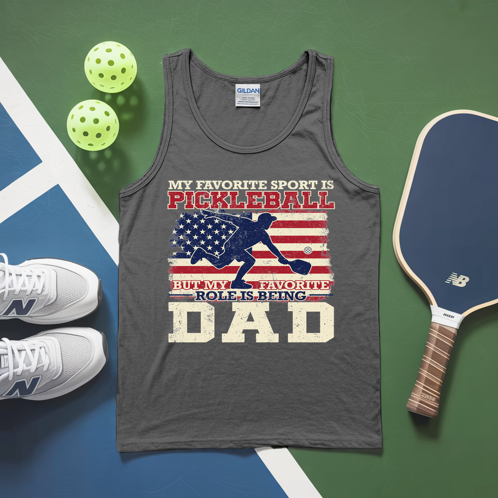Gray tank top with pickleball-themed design on a green and blue surface with pickleballs and a paddle.