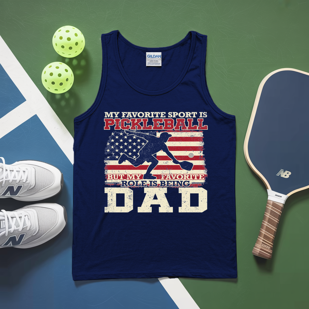 Navy tank top with pickleball-themed design on a green and blue surface with pickleballs and a paddle.