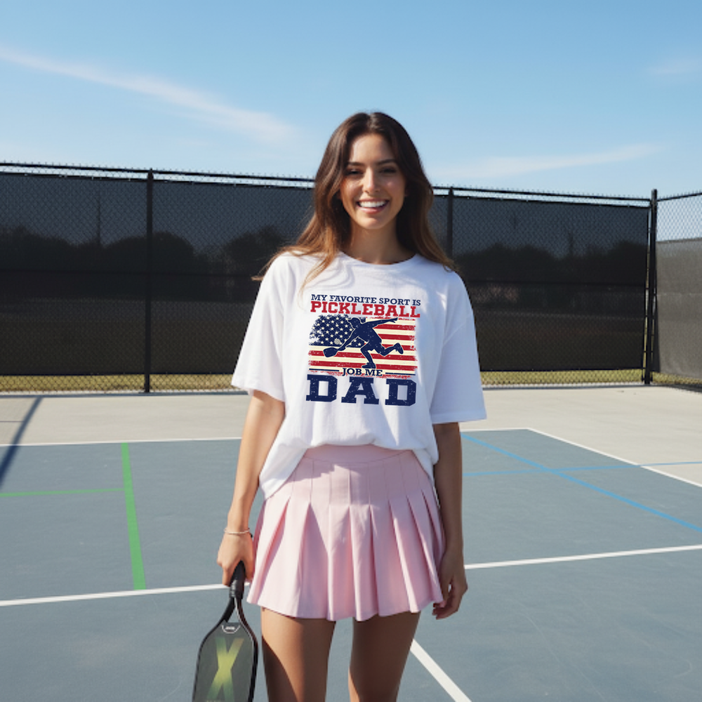 Woman on a tennis court wearing a t-shirt with text and an American flag graphic.