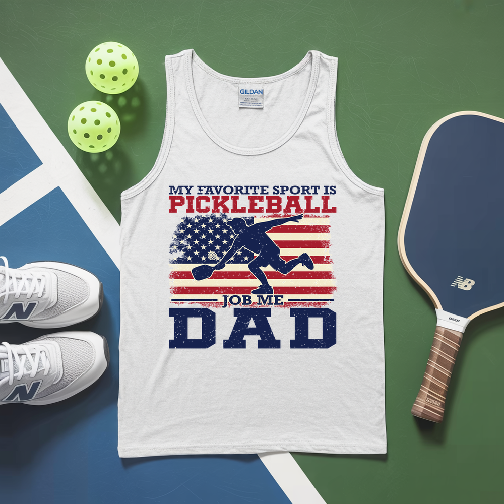White tank top with pickleball-themed design on a green and blue surface with pickleballs and a paddle.
