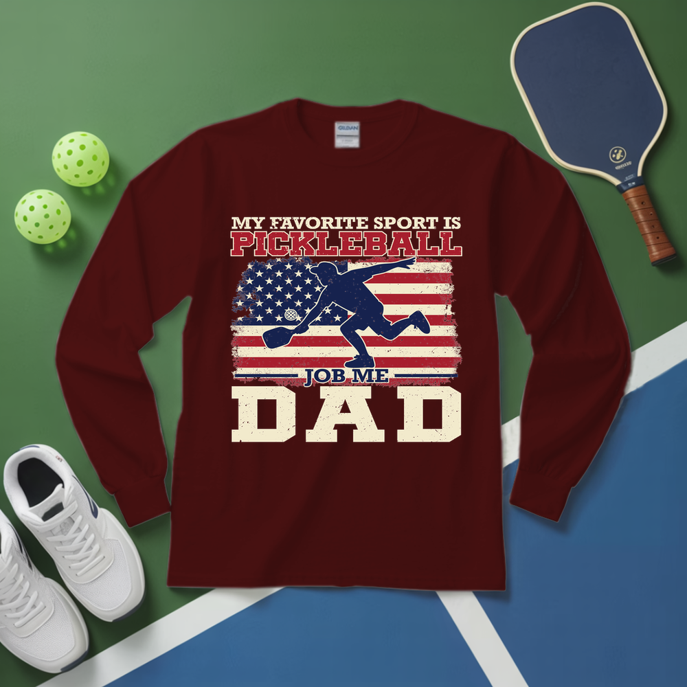 Maroon long-sleeve shirt with pickleball-themed design on a green and blue surface with pickleball equipment.