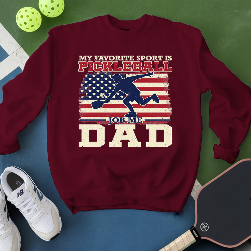 Maroon sweatshirt with pickleball-themed design on a blue and green background