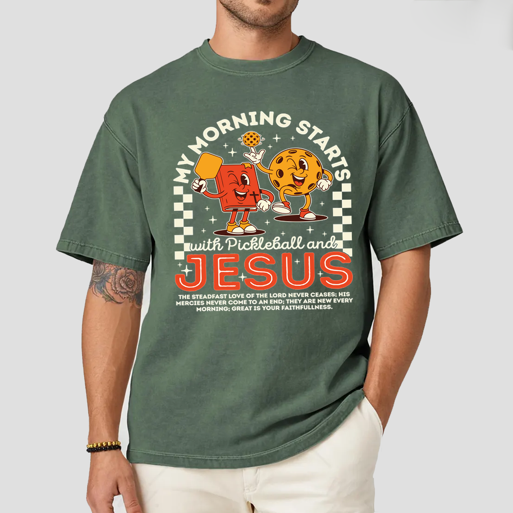 Person wearing a green t-shirt with a graphic design and text.