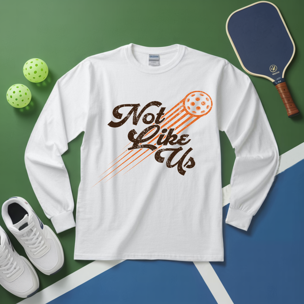 White long-sleeve shirt with 'Not Like Up' design on a green and blue background with pickleball equipment.