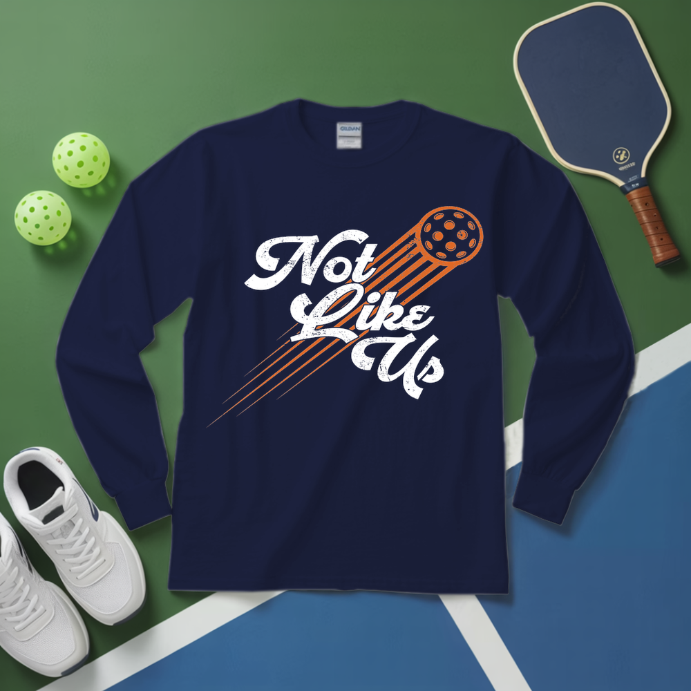 Navy blue long-sleeve shirt with 'Not Like Us' graphic on a green and blue background with pickleball equipment.