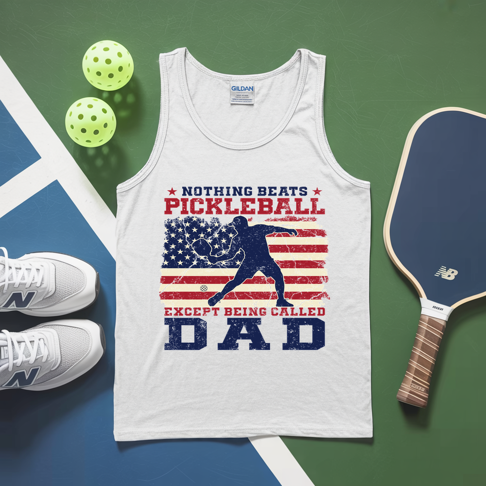 White tank top with pickleball-themed design on a green and blue surface with pickleballs and a paddle.