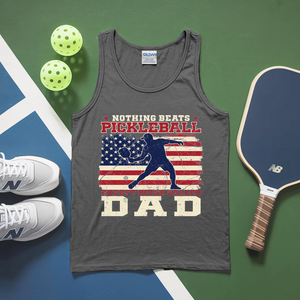 Gray tank top with pickleball design and accessories on a green and blue surface