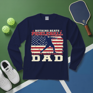 Navy blue sweatshirt with pickleball design on a green and blue surface with pickleball equipment.