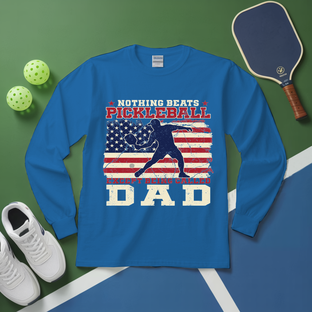 Blue long-sleeve shirt with pickleball design on a green and blue background