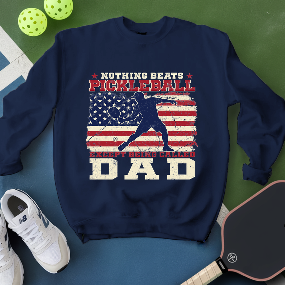Navy blue sweatshirt with pickleball design and text on a green and blue background