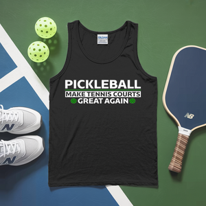 Black tank top with pickleball-themed text on a green and blue surface with pickleballs and a paddle.