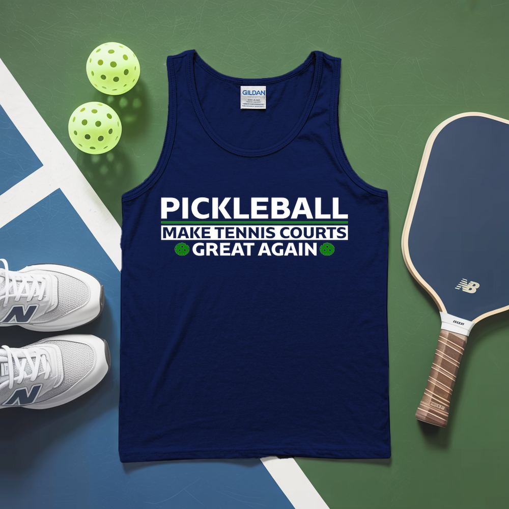 Blue tank top with pickleball text on a green and blue surface with pickleballs and a paddle.