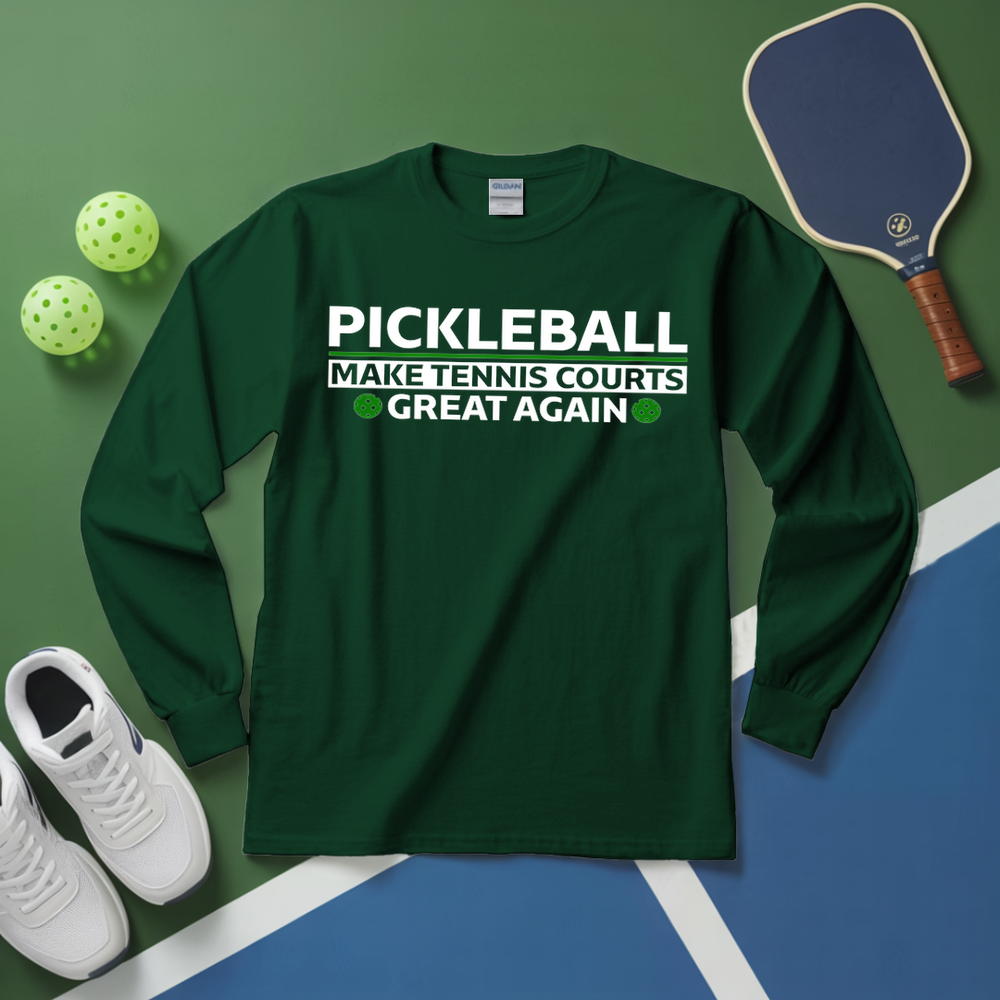 Green long-sleeve shirt with pickleball text on a green and blue surface with pickleball equipment.