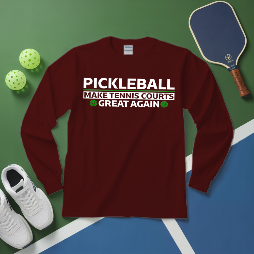 Maroon long-sleeve shirt with pickleball text on a green and blue surface with pickleball equipment.