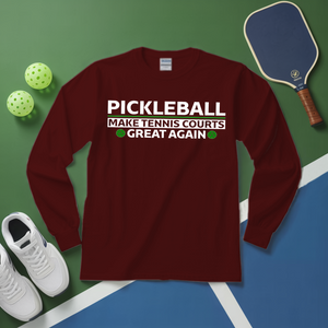 Maroon long-sleeve shirt with pickleball text on a green and blue surface with pickleball equipment.