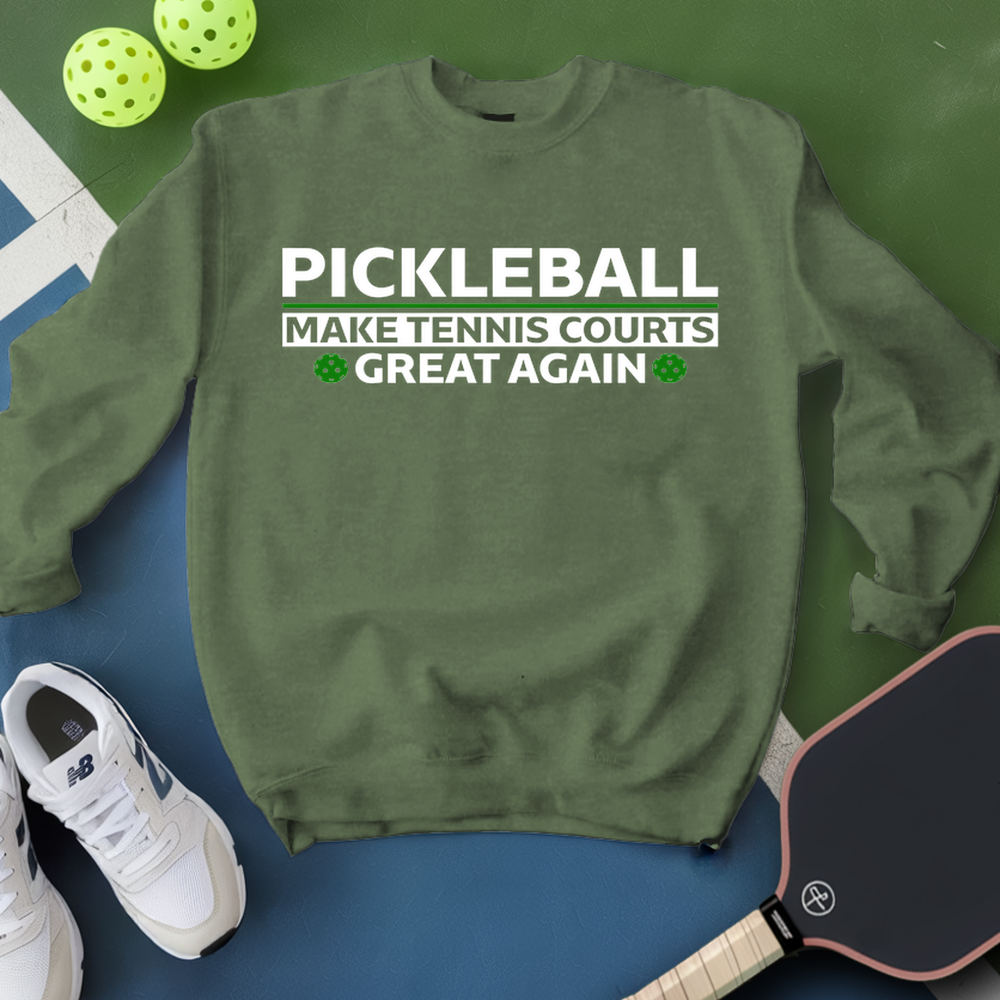 Green sweatshirt with pickleball text, pickleball paddle, and balls on a green and blue background