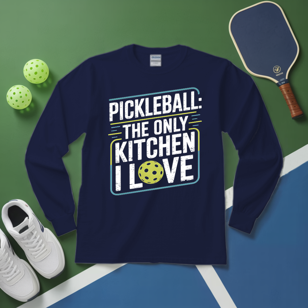 Navy blue sweatshirt with pickleball-themed text on a green and blue surface with pickleballs and a paddle.