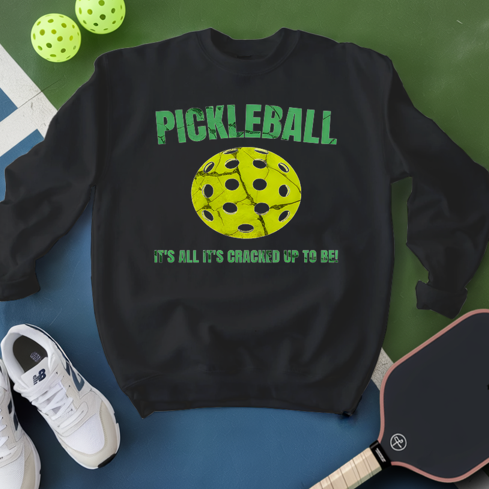 Black sweatshirt with pickleball graphic and text on a green and blue background