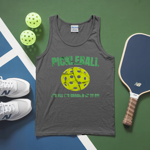 Gray tank top with pickleball design and text, pickleballs, and paddle on a green and blue surface.
