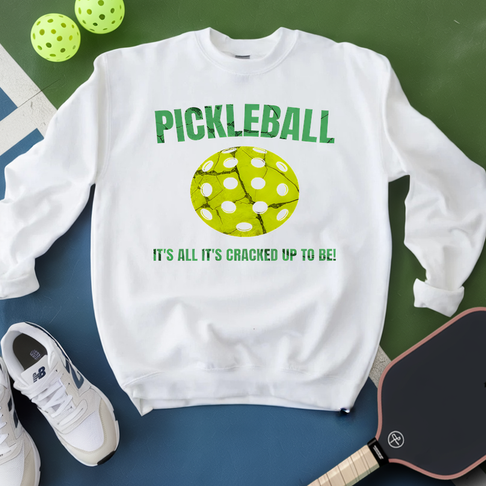 White sweatshirt with pickleball design and text on a green and blue background