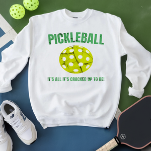 White sweatshirt with pickleball design and text on a green and blue background