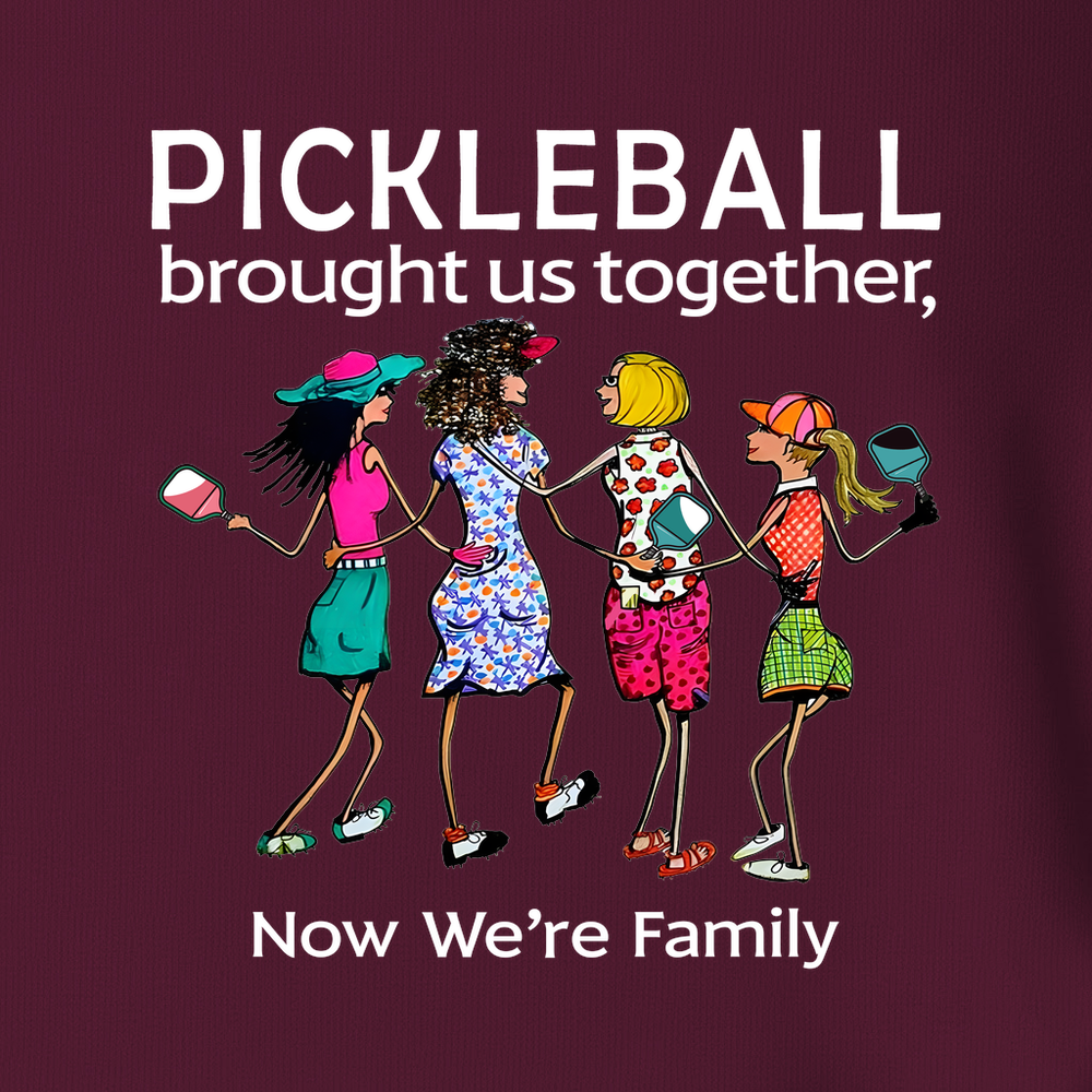 Maroon t-shirt with pickleball-themed design and accessories on a white background