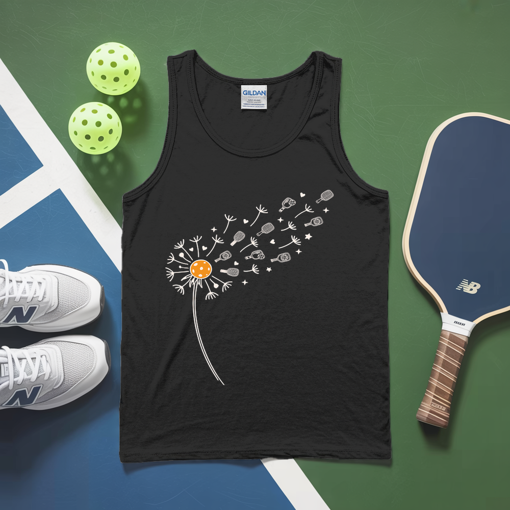 Black tank top with a dandelion design on a green and blue surface with pickleballs and a paddle.