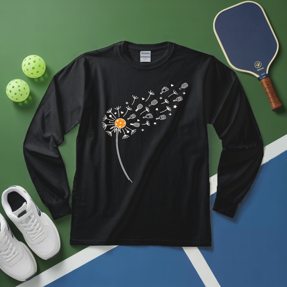 Black long-sleeve shirt with dandelion design on a green and blue surface with sports equipment.
