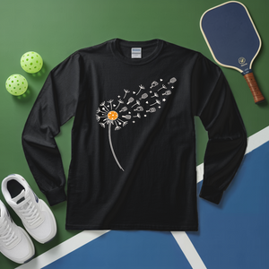 Black long-sleeve shirt with dandelion design on a green and blue surface with sports equipment.