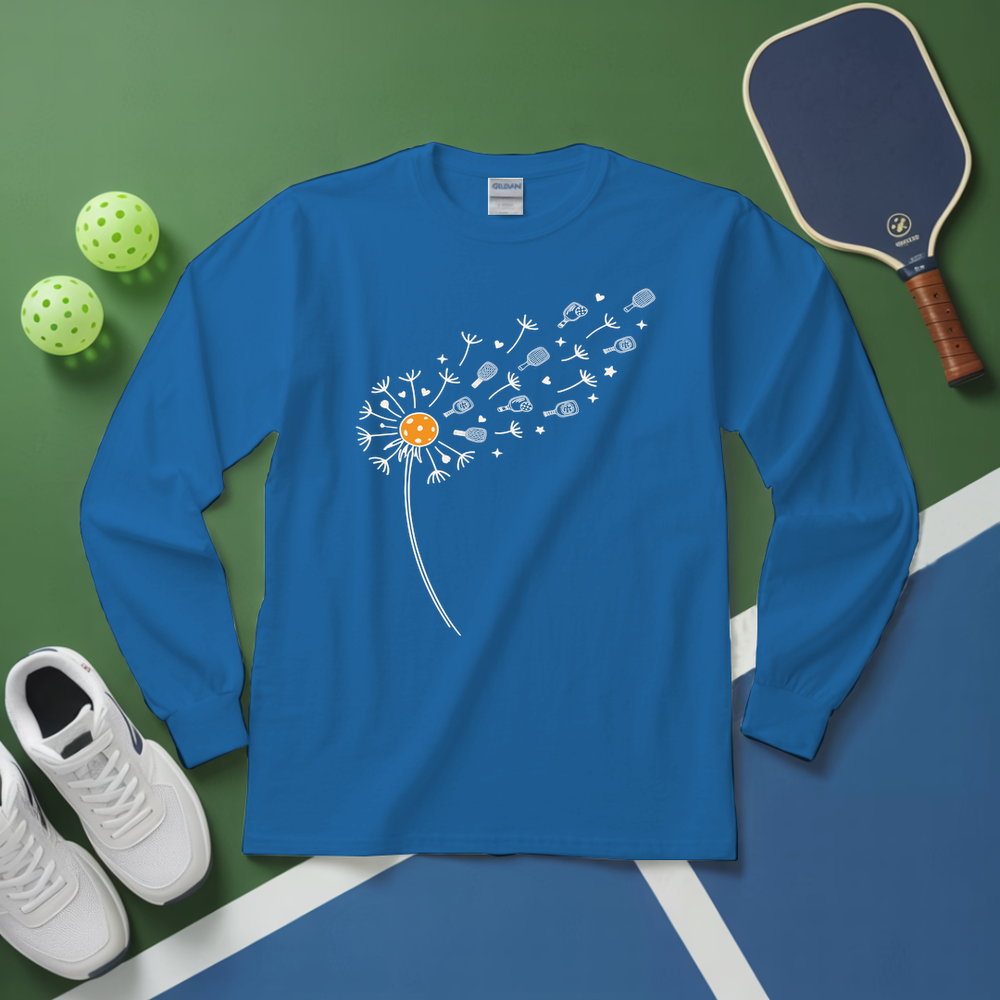 Blue long-sleeve shirt with dandelion design on a green and blue surface with sports equipment.