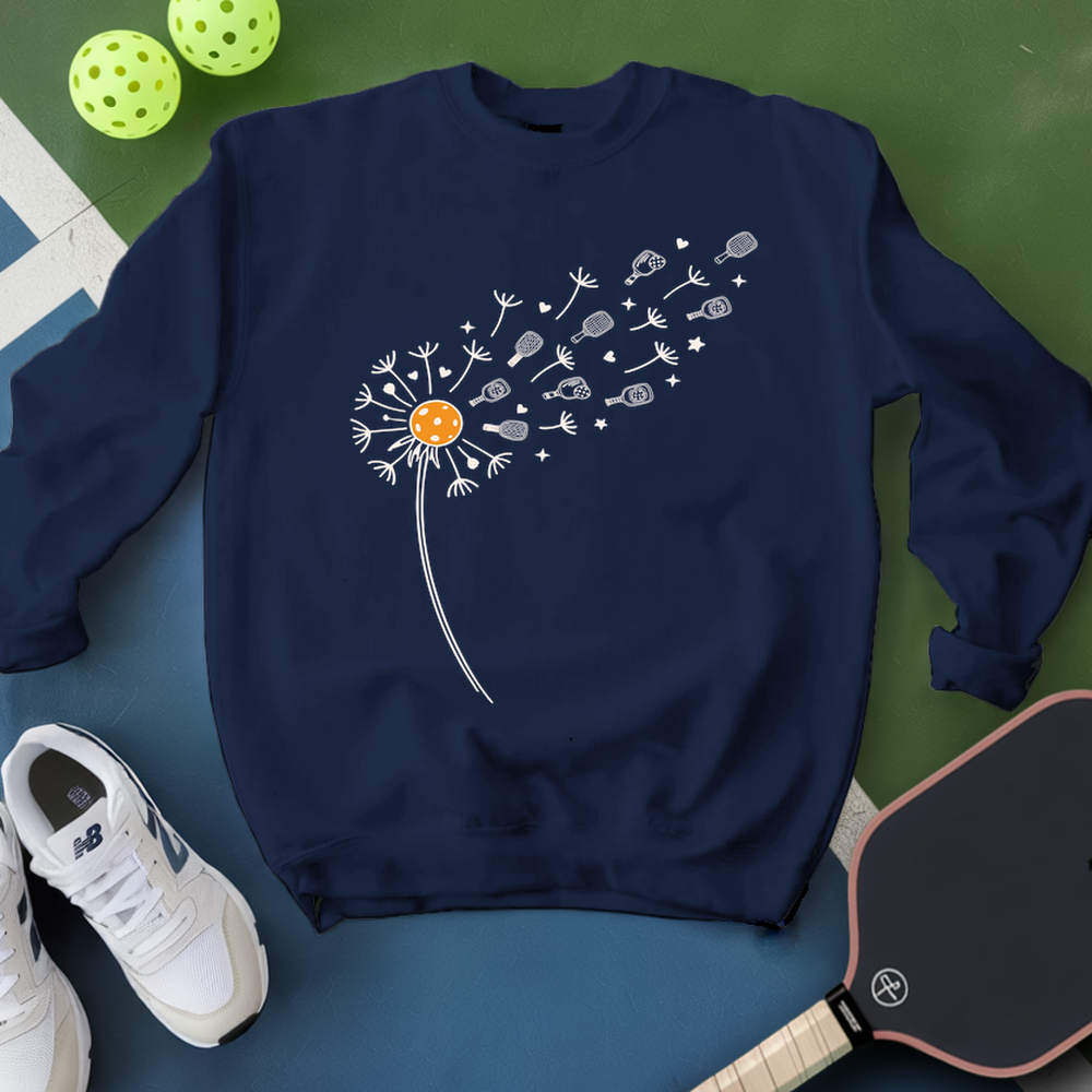 Navy blue sweatshirt with dandelion graphic on a green and blue surface with sports equipment.