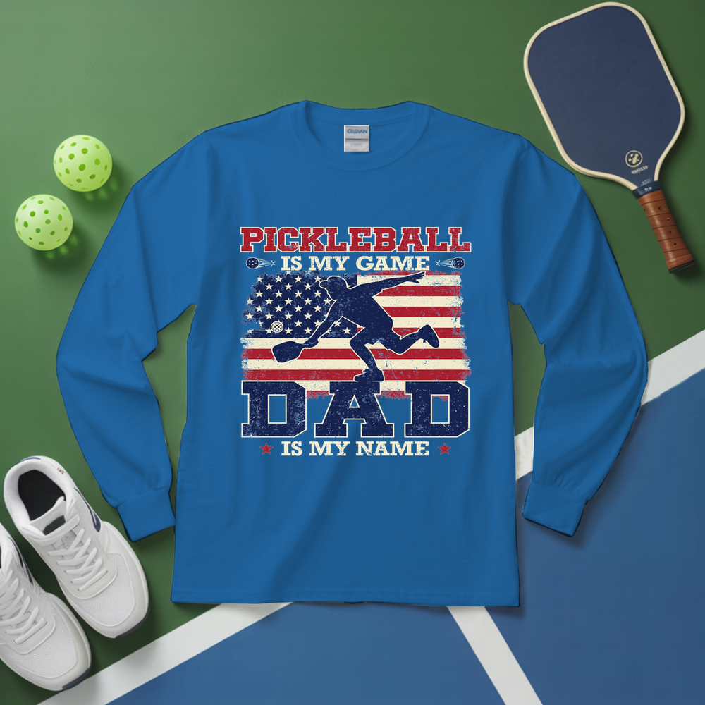 Blue long-sleeve shirt with pickleball design on a green and blue background