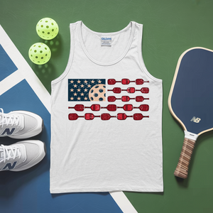 White tank top with pickleball design, shoes, paddle, and balls on a green and blue surface
