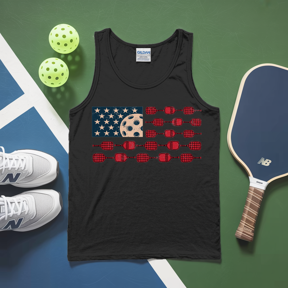 Black tank top with pickleball design on a green and blue surface with pickleballs and a paddle.